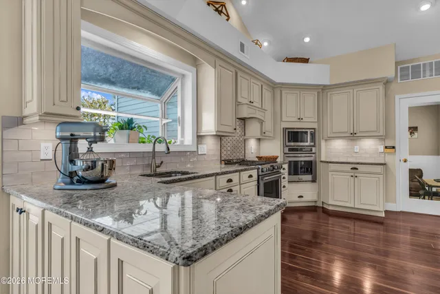 a living room with a bed and dresser