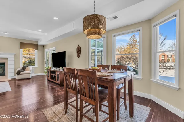 a view of a patio with table and chairs potted plants with wooden floor and fence
