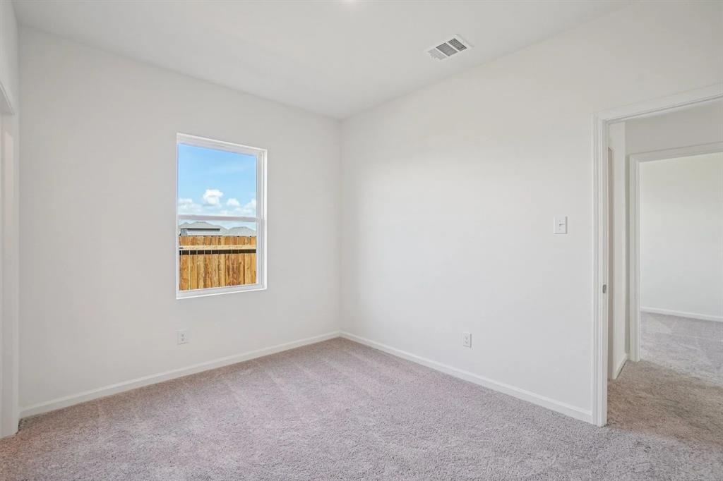4508 Winecup Road Melissa, TX 75454 - Photo 12 of 14 Empty room featuring light colored carpet and baseboards