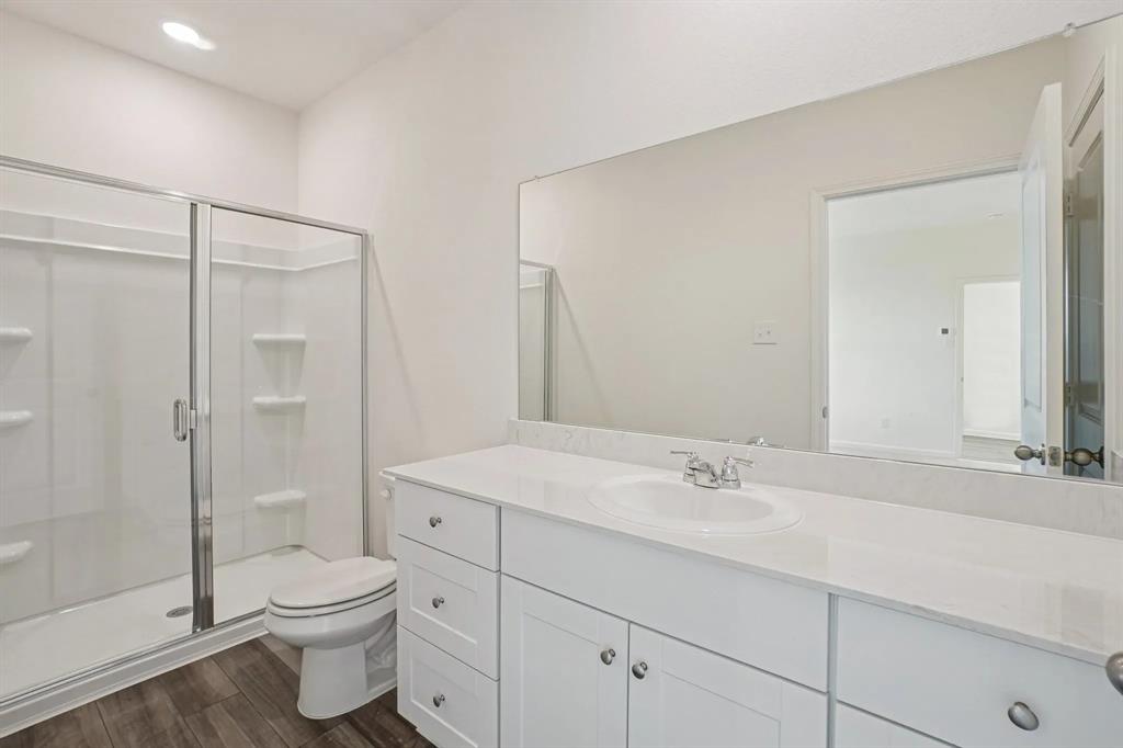 4508 Winecup Road Melissa, TX 75454 - Photo 13 of 14 Full bath featuring a stall shower, vanity, and dark wood-style flooring