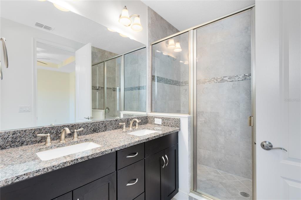 13969 Arclid Street Orlando, FL 32832 - Photo 11 of 29 a bathroom with a granite countertop sink mirror and double