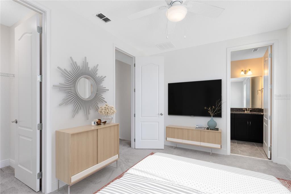 13969 Arclid Street Orlando, FL 32832 - Photo 13 of 29 a bedroom with a bed and a flat screen tv