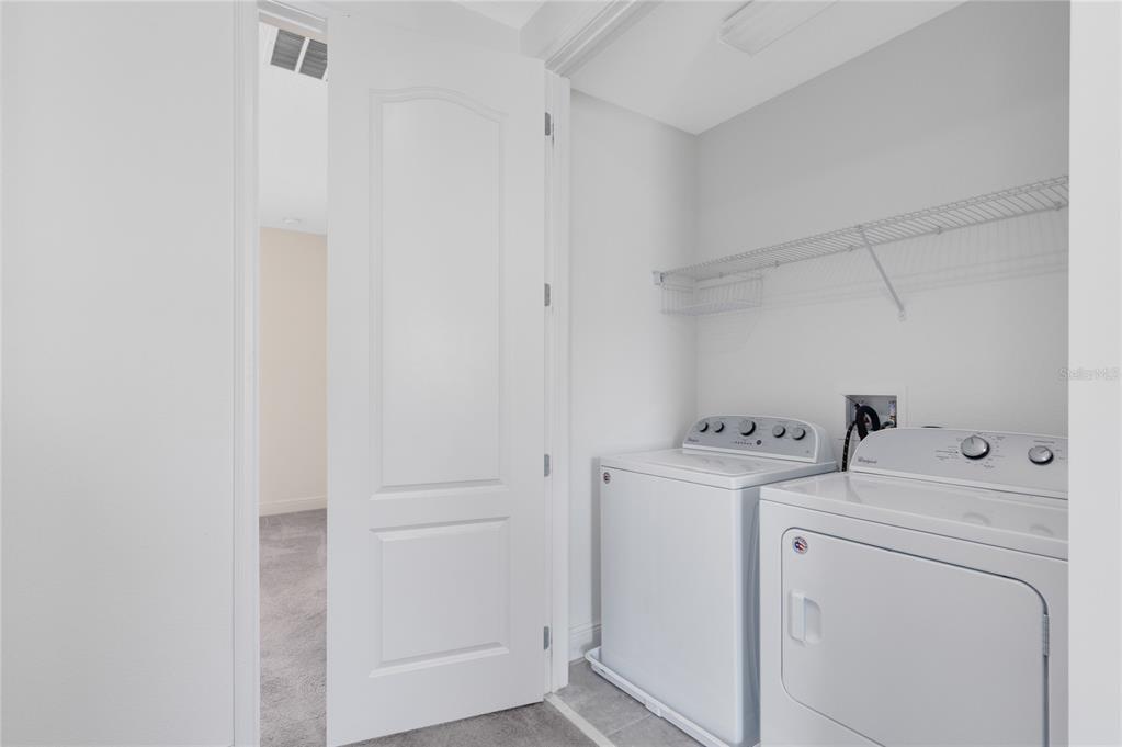 13969 Arclid Street Orlando, FL 32832 - Photo 15 of 29 a view of storage and utility room with washer and dryer