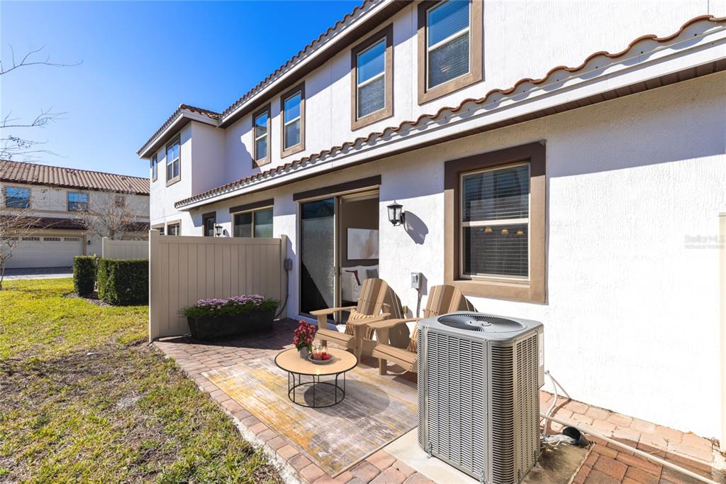 13969 Arclid Street Orlando, FL 32832 - Photo 17 of 29 a view of a patio with table and chairs and potted plants