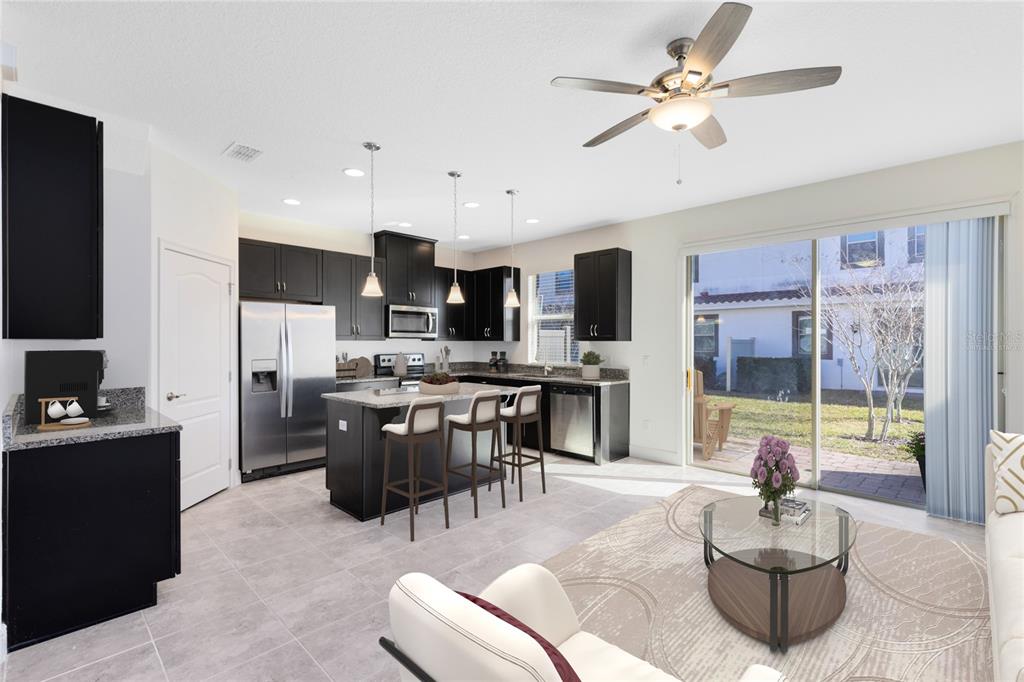 13969 Arclid Street Orlando, FL 32832 - Photo 3 of 29 a living room with stainless steel appliances furniture a chandelier and a kitchen view