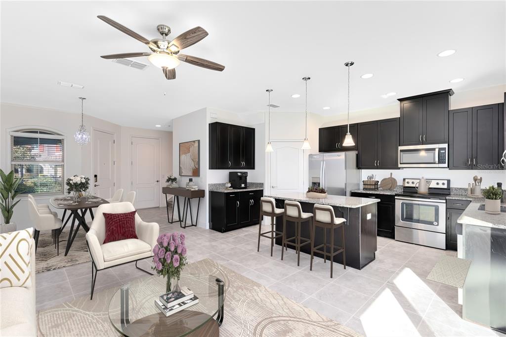 13969 Arclid Street Orlando, FL 32832 - Photo 4 of 29 a living room with furniture kitchen view and a flat screen tv