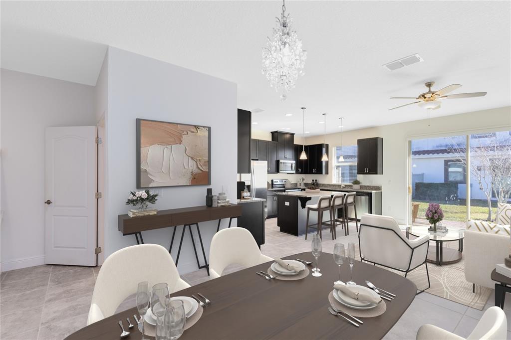 13969 Arclid Street Orlando, FL 32832 - Photo 7 of 29 a living room with furniture kitchen view and a chandelier