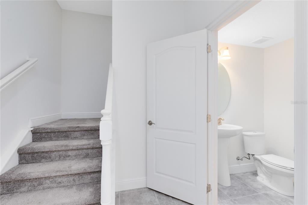 13969 Arclid Street Orlando, FL 32832 - Photo 8 of 29 a bathroom with a toilet and a shower