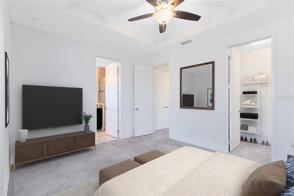 13969 Arclid Street Orlando, FL 32832 - Photo 10 of 29 a bedroom with a bed and a flat tv screen