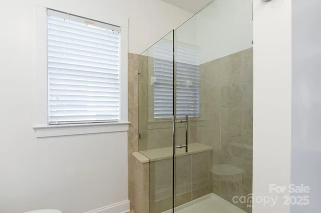 a bathroom with a shower and a window