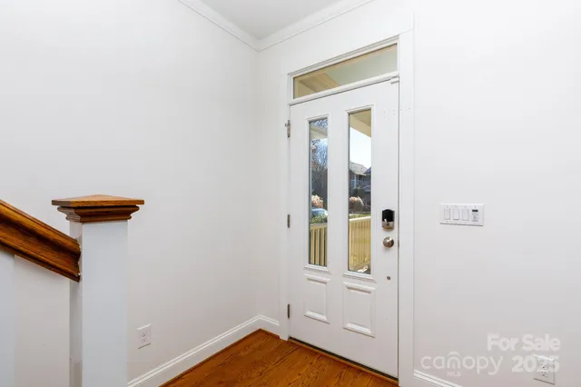 a view of an entryway with wooden floor