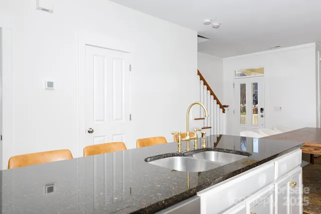 a kitchen with granite countertop a sink and a cabinets
