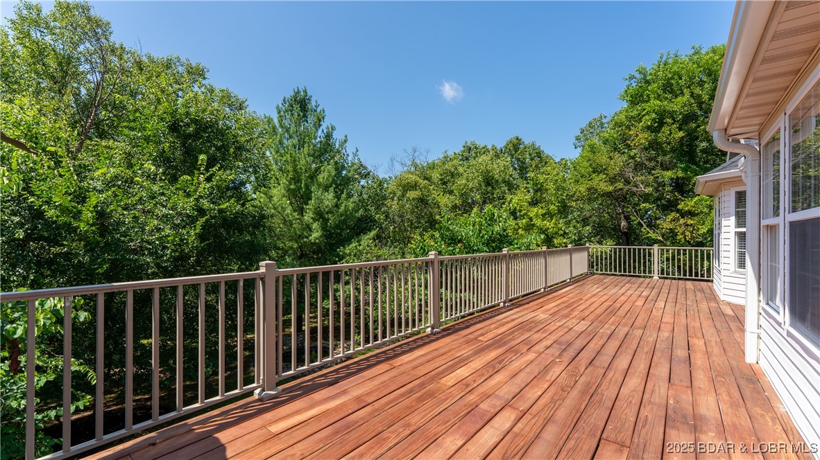 165 Lake Shadow Road Sunrise Beach, MO 65079 - Photo 15 of 50 Massive deck overlooks the back yard oasis and off
