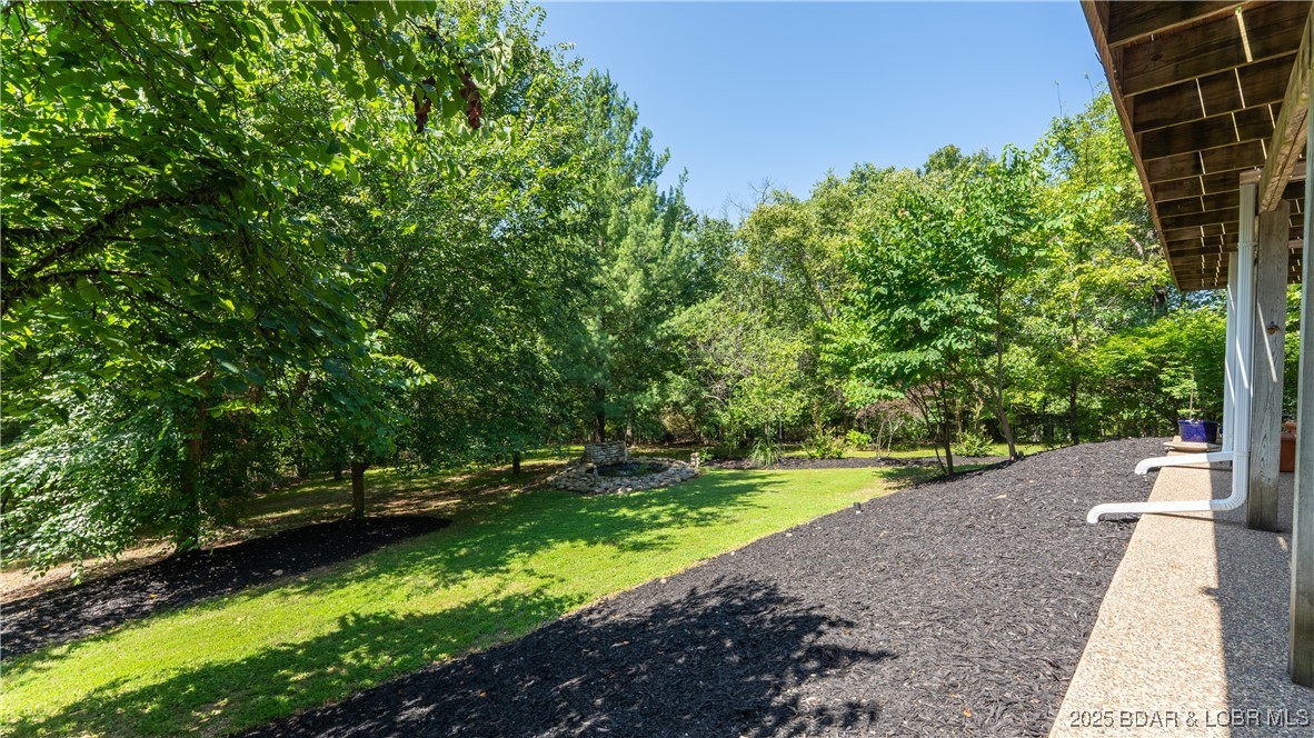 165 Lake Shadow Road Sunrise Beach, MO 65079 - Photo 37 of 50 Meticulously maintained landscaping enhances backy