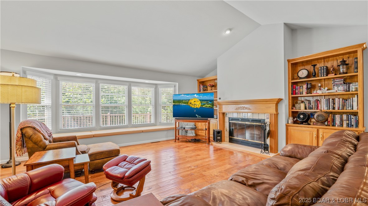 165 Lake Shadow Road Sunrise Beach, MO 65079 - Photo 7 of 50 Expansive living room with woodburning fireplace a
