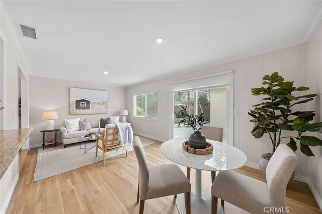 a living room with furniture a chandelier and a wooden floor