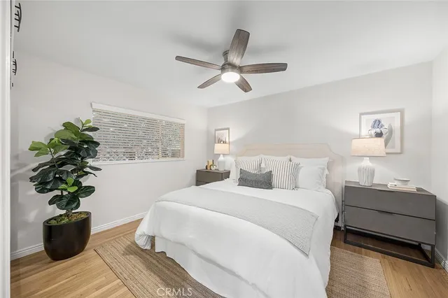 a bedroom with a large bed and a potted plant