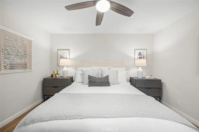 a bedroom with a bed and wooden floor