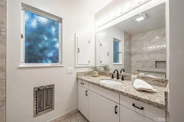 a bathroom with a sink and a mirror