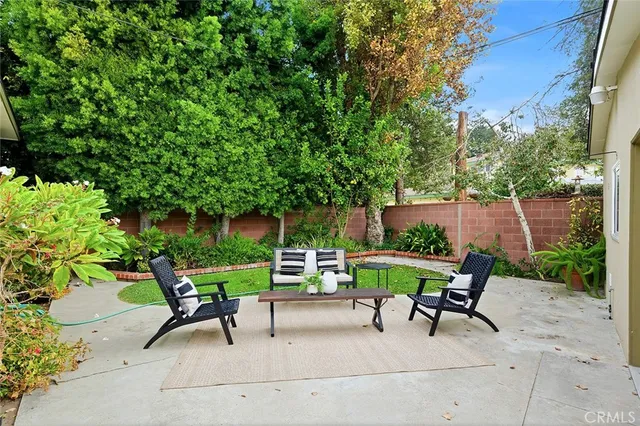 a view of backyard with seating and green space