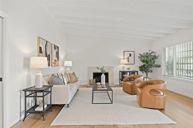 a living room with furniture a rug and a fireplace