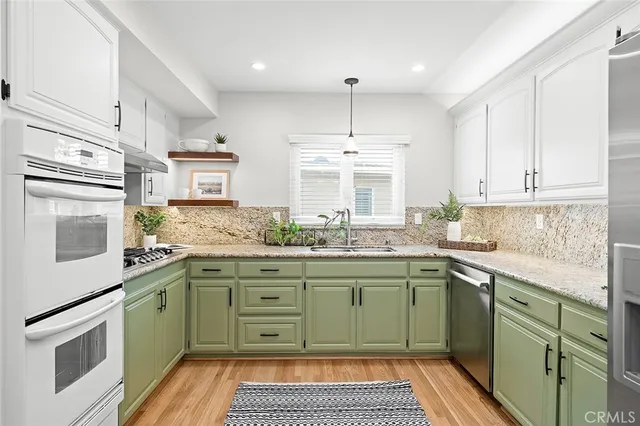a kitchen with a sink stove and cabinets