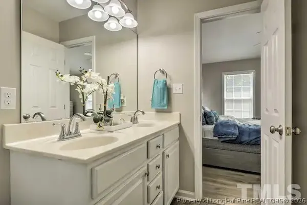 a bathroom with a double vanity sink mirror and