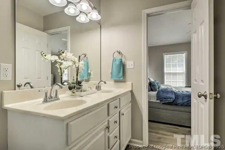 3911 Volkswalk Place Raleigh, NC 27610 - Photo 11 of 17 a bathroom with a double vanity sink mirror and