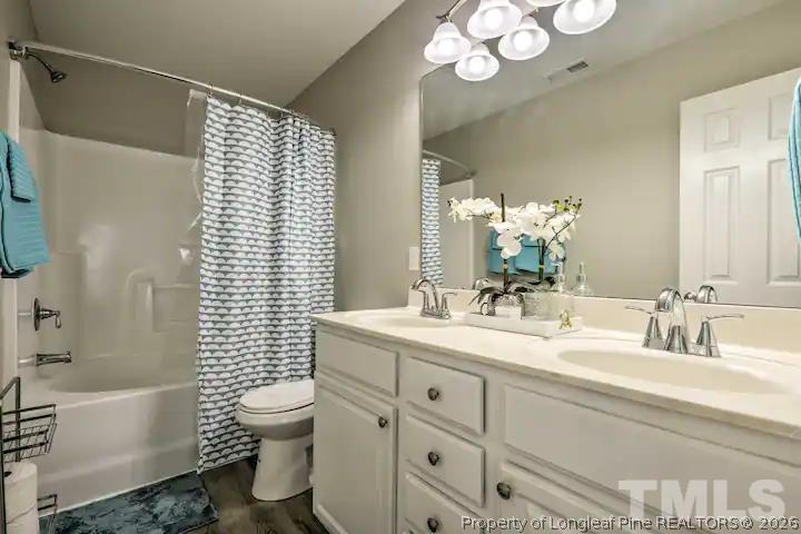3911 Volkswalk Place Raleigh, NC 27610 - Photo 12 of 17 a bathroom with a sink a toilet and bathtub