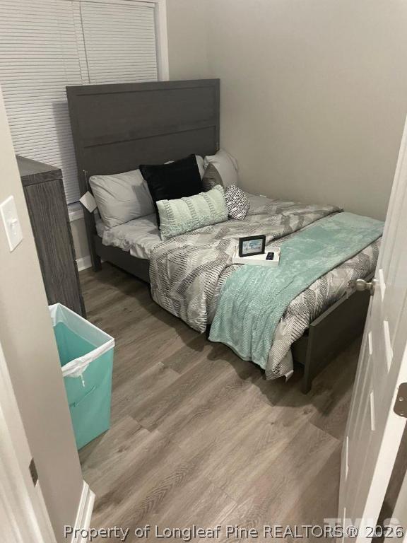 3911 Volkswalk Place Raleigh, NC 27610 - Photo 13 of 17 a bed sitting in a bedroom next to a window with wooden floor