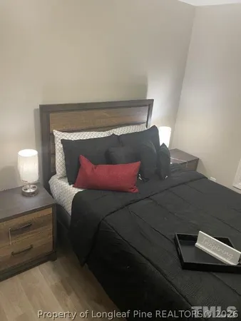 a bedroom with a bed and a lamp