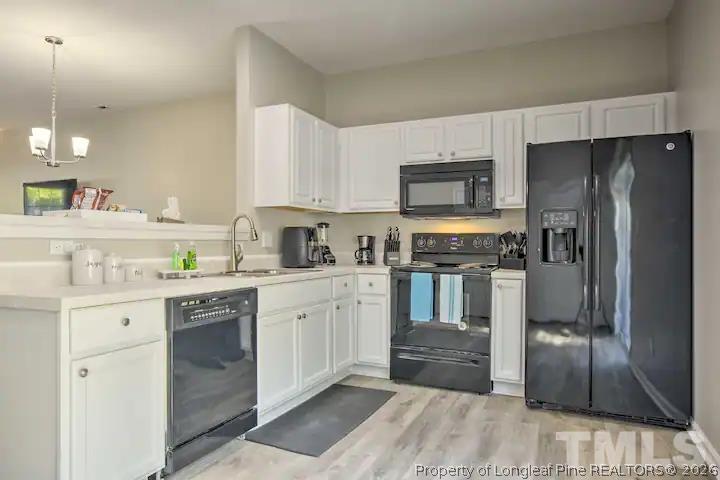 3911 Volkswalk Place Raleigh, NC 27610 - Photo 6 of 17 a kitchen with granite countertop a refrigerator stove and sink