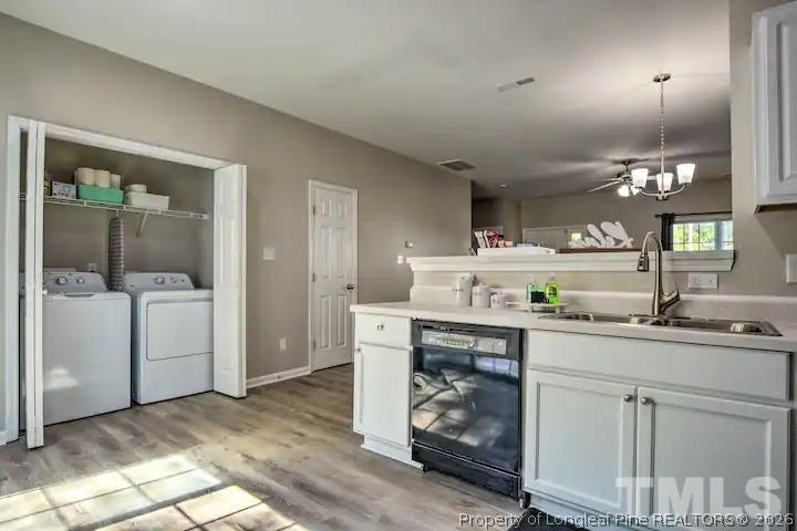 3911 Volkswalk Place Raleigh, NC 27610 - Photo 7 of 17 a kitchen with a sink cabinets and wooden floor