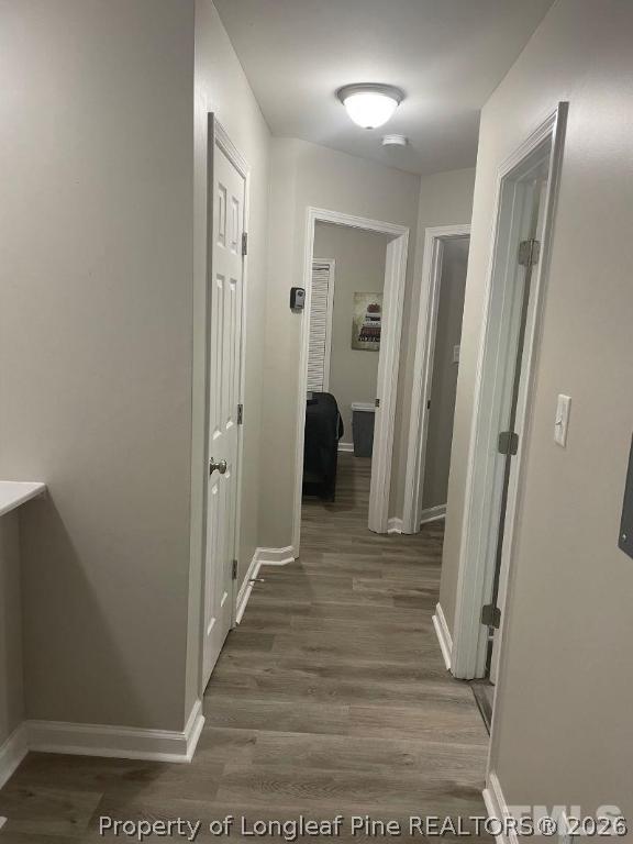 3911 Volkswalk Place Raleigh, NC 27610 - Photo 8 of 17 a view of a hallway with wooden floor and a bathroom