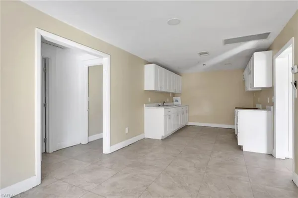 a view of a kitchen with white cabinets