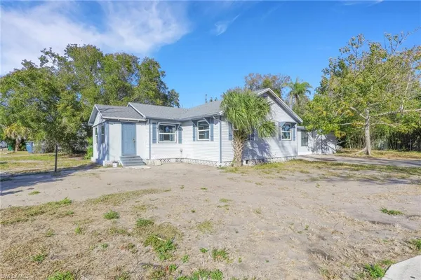 a view of a house with a yard and garage
