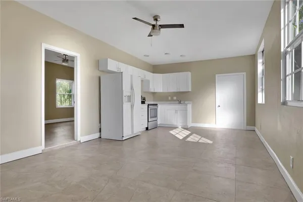 a view of a kitchen with a sink and a refrigerator