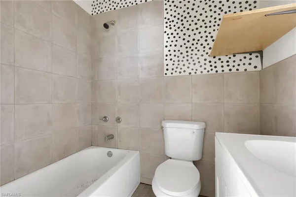 a bathroom with a toilet a sink and a bathtub