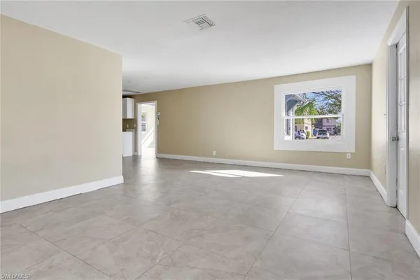 an empty room with windows and closet