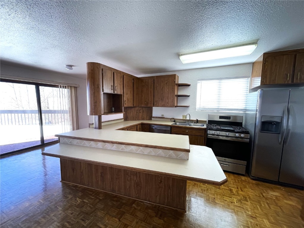2584 High Creek Road Fairplay, CO 80440 - Photo 3 of 50 a large kitchen with stainless steel appliances granite countertop a stove a sink dishwasher a microwave oven and a refrigerator with wooden floor