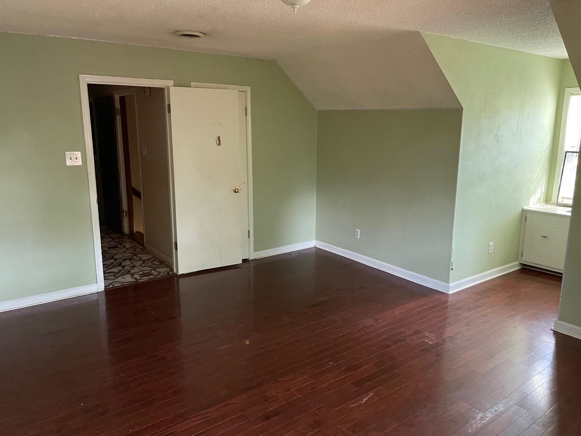4339 Timber Rise Road Memphis, TN 38125 - Photo 9 of 11 an empty room with wooden floor and windows