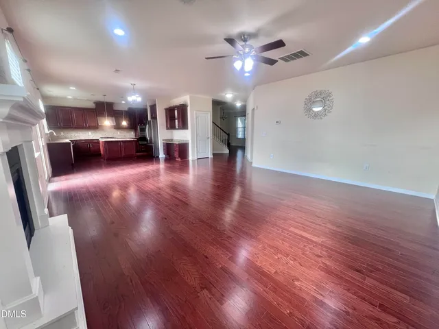 a large kitchen with stainless steel appliances granite countertop a stove a sink dishwasher and a refrigerator