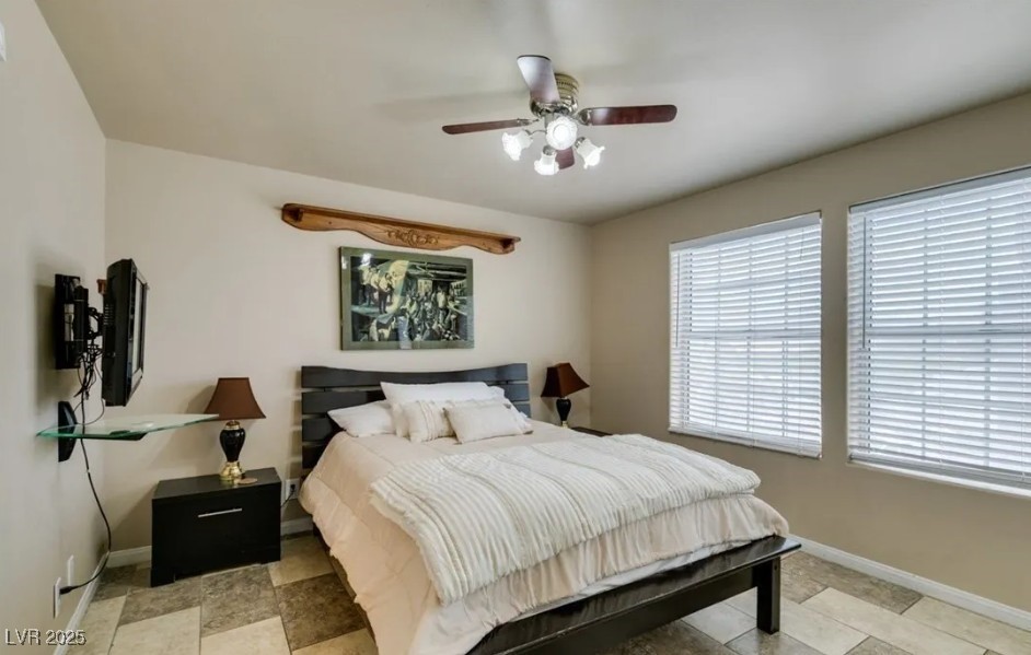 6520 Turtle Hill Road Las Vegas, NV 89110 - Photo 24 of 59 Bedroom with ceiling fan and light stone finish floors