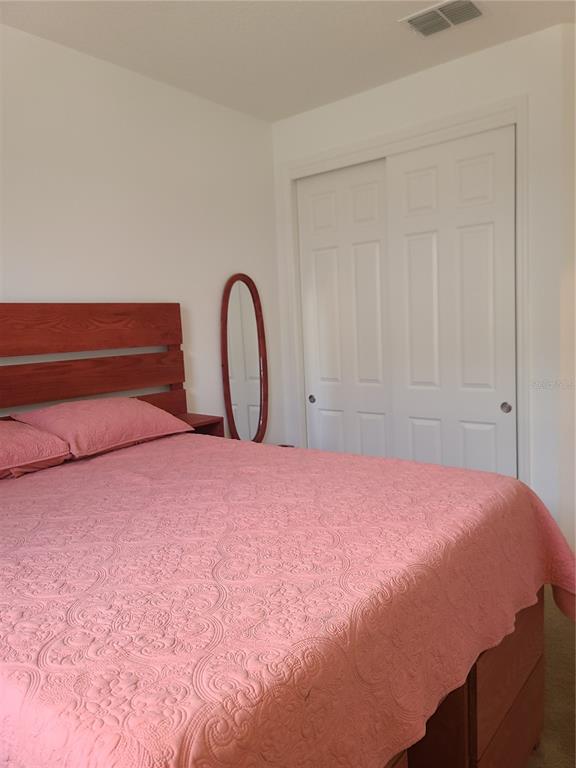 5380 Northwest 43rd Ln Road Ocala, FL 34482 - Photo 23 of 54 a bedroom with a bed and a potted plant