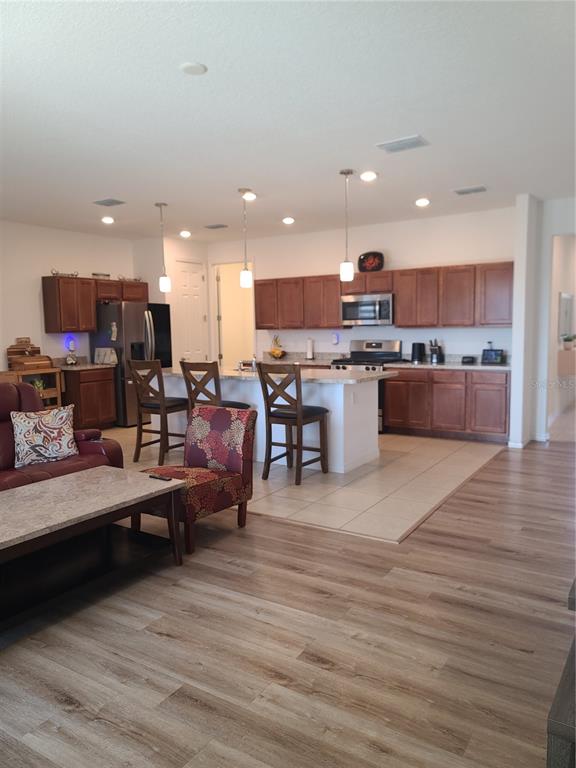 5380 Northwest 43rd Ln Road Ocala, FL 34482 - Photo 26 of 54 a living room with lots of furniture and kitchen view
