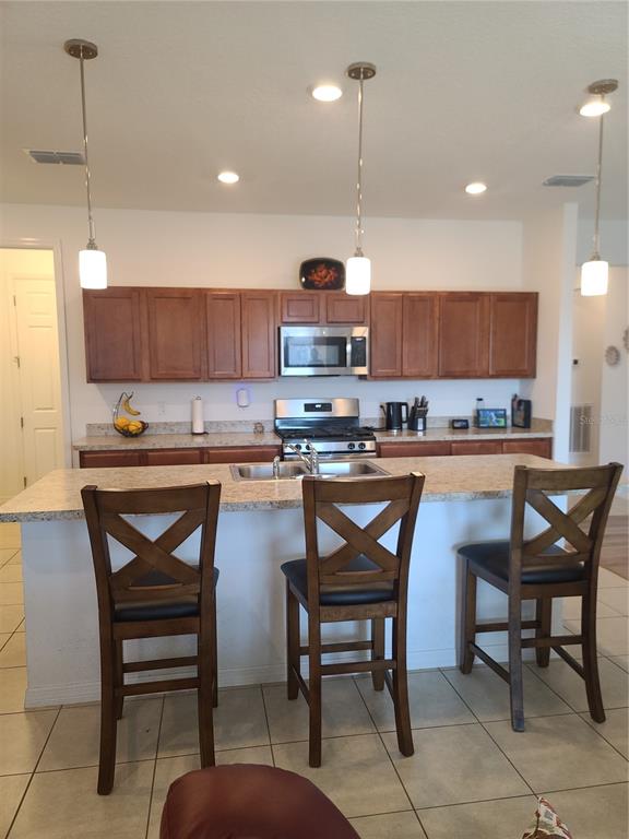 5380 Northwest 43rd Ln Road Ocala, FL 34482 - Photo 27 of 54 a kitchen with a dining table chairs and white cabinets