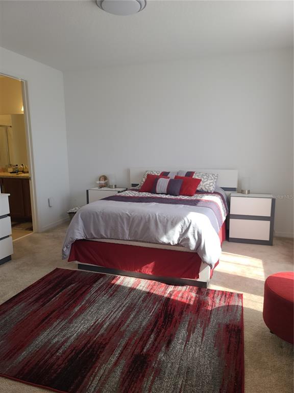 5380 Northwest 43rd Ln Road Ocala, FL 34482 - Photo 43 of 54 a bedroom with a bed and wooden floor