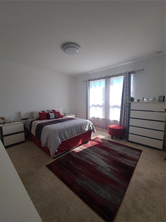 5380 Northwest 43rd Ln Road Ocala, FL 34482 - Photo 44 of 54 a bedroom with two beds and a large window