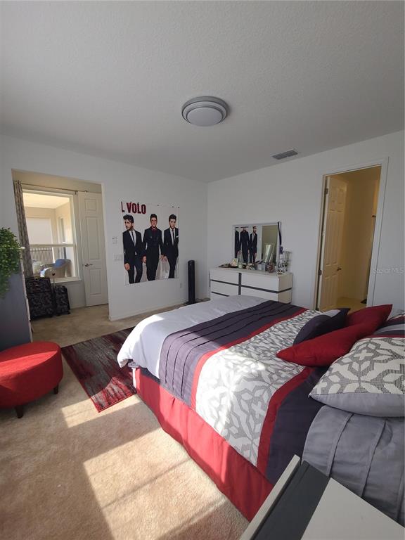 5380 Northwest 43rd Ln Road Ocala, FL 34482 - Photo 45 of 54 a bedroom with bed and a couch