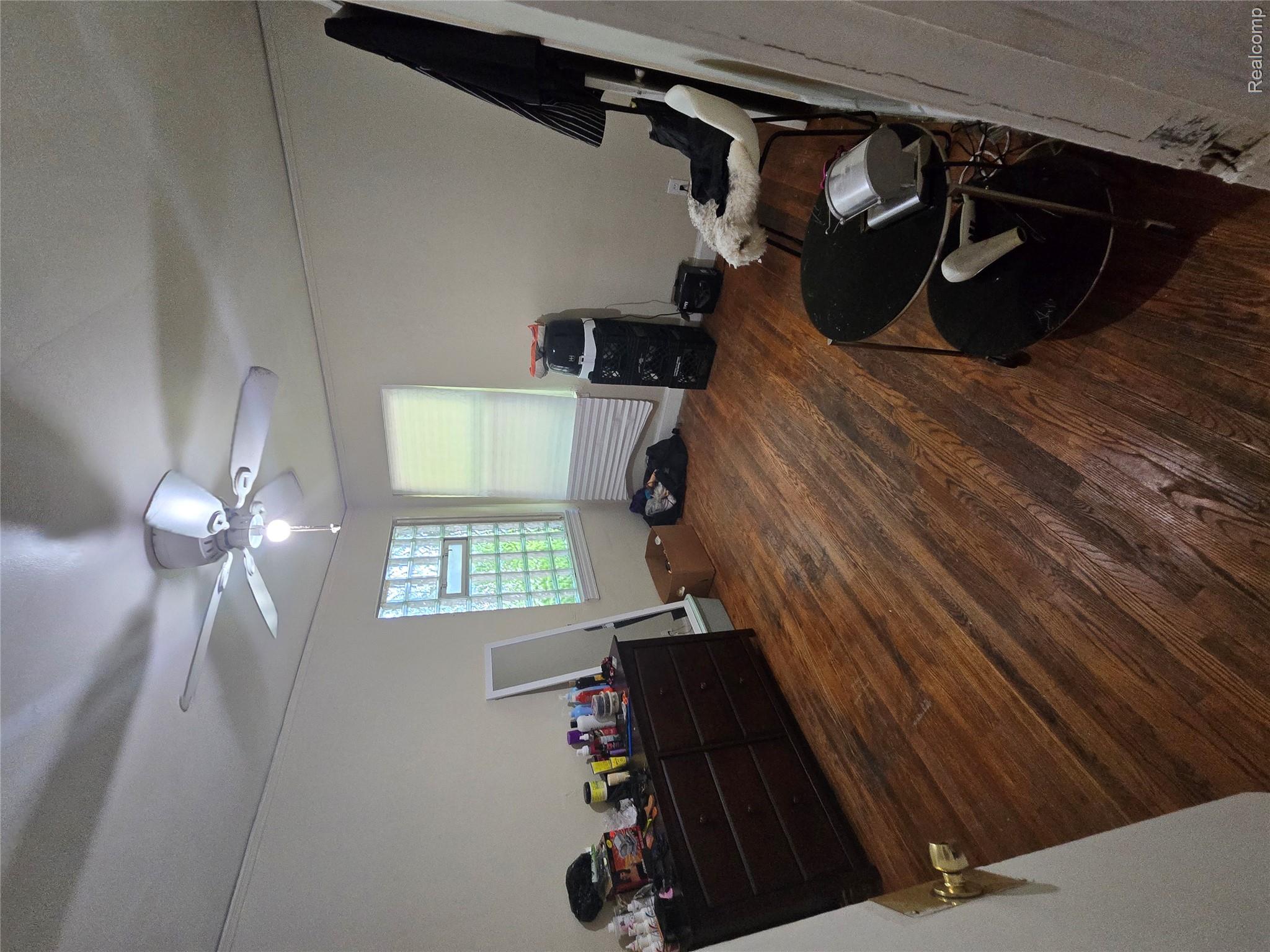10342 Roxbury Street Detroit, MI 48224 - Photo 22 of 30 Hardwood flooring, ceiling fan with integrated lighting, glass block window, and window with blinds